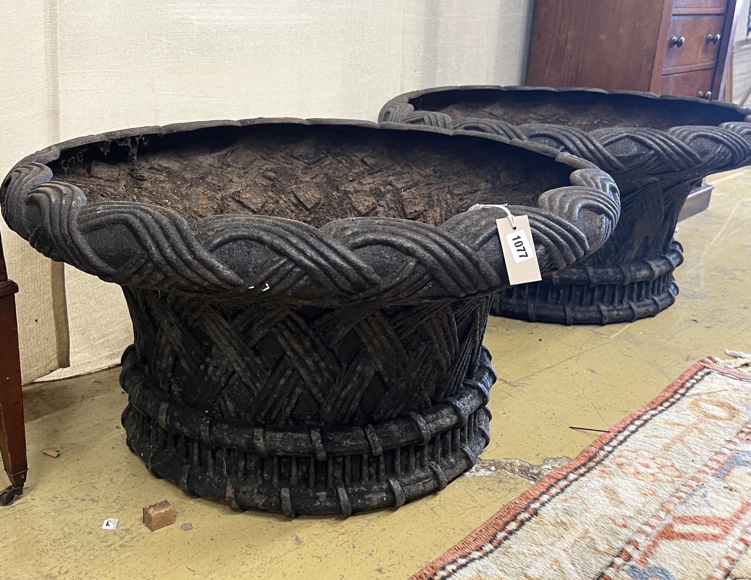 A large pair of circular weathered cast iron planters, diameter 82cm, height 43cm